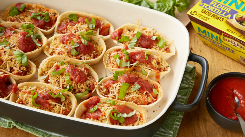 Old El Paso Mini Soft Tortilla Bowls filled with chicken parmesan lasagna in a large oven casserole dish.